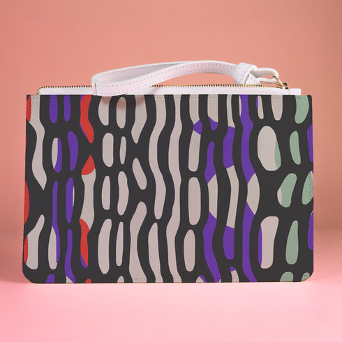 Rectangular wristlet clutch bag with psychedelic black, purple, red, and green pattern. White wrist strap and gold zipper visible